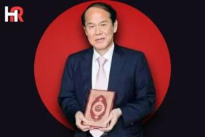 Dr. Hamid Choi Yong Kil holding the Korean translation of the Holy Quran.