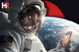 NASA astronaut holding a smartphone in orbit; Artemis II crew members using mobile technology for communication.