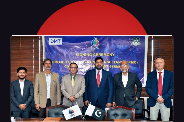 A formal group photograph showing six men in business suits standing in a row behind a conference table. Behind them hangs a blue banner that reads 'SIGNING CEREMONY' and displays the logos for DMT and PPL. On the table in the foreground, small flags for PPL and Pakistan sit next to document folders. The photograph is framed against a dark background with a large red semi-circle at the top.