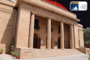 A stylized image featuring the classical stone facade of the Overseas Investors Chamber of Commerce & Industry (OICCI) building, characterized by its grand pillars and wide steps. The official OICCI logo is visible in the top right corner, and a massive, solid red circle is superimposed on the dark sky in the background.