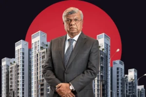 An older man in a dark suit and patterned tie stands with his hands clasped in the foreground. Behind him is a row of modern, high-rise white apartment buildings. The scene is set against a dark background with a massive, solid red circle positioned directly behind the man. His name is Arif habib.