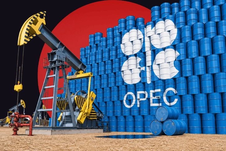 A stylized conceptual image featuring a blue and yellow oil pumpjack operating on a sandy surface next to a massive wall of stacked blue oil barrels. The large white OPEC logo is painted across the barrels. The scene is set against a dark background dominated by a giant, solid red circle.
