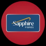 The corporate logo of Sapphire Fibres featuring white text and an orange swoosh inside a blue rounded rectangle, centered on a massive solid red circular background against a dark backdrop.